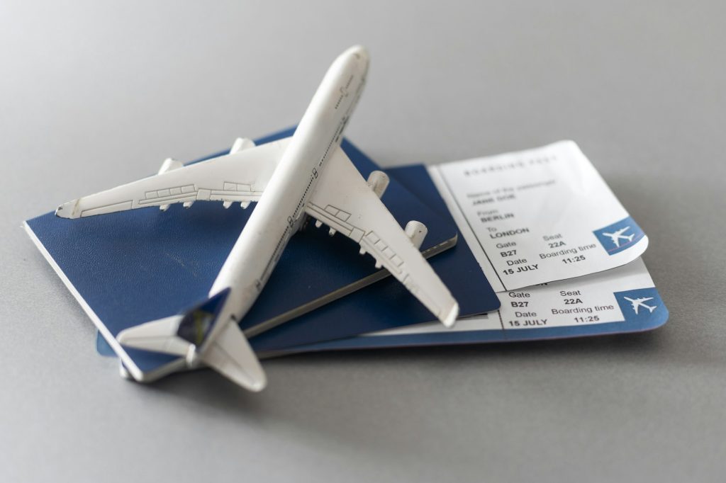 Airline tickets and documents on wooden table, top view